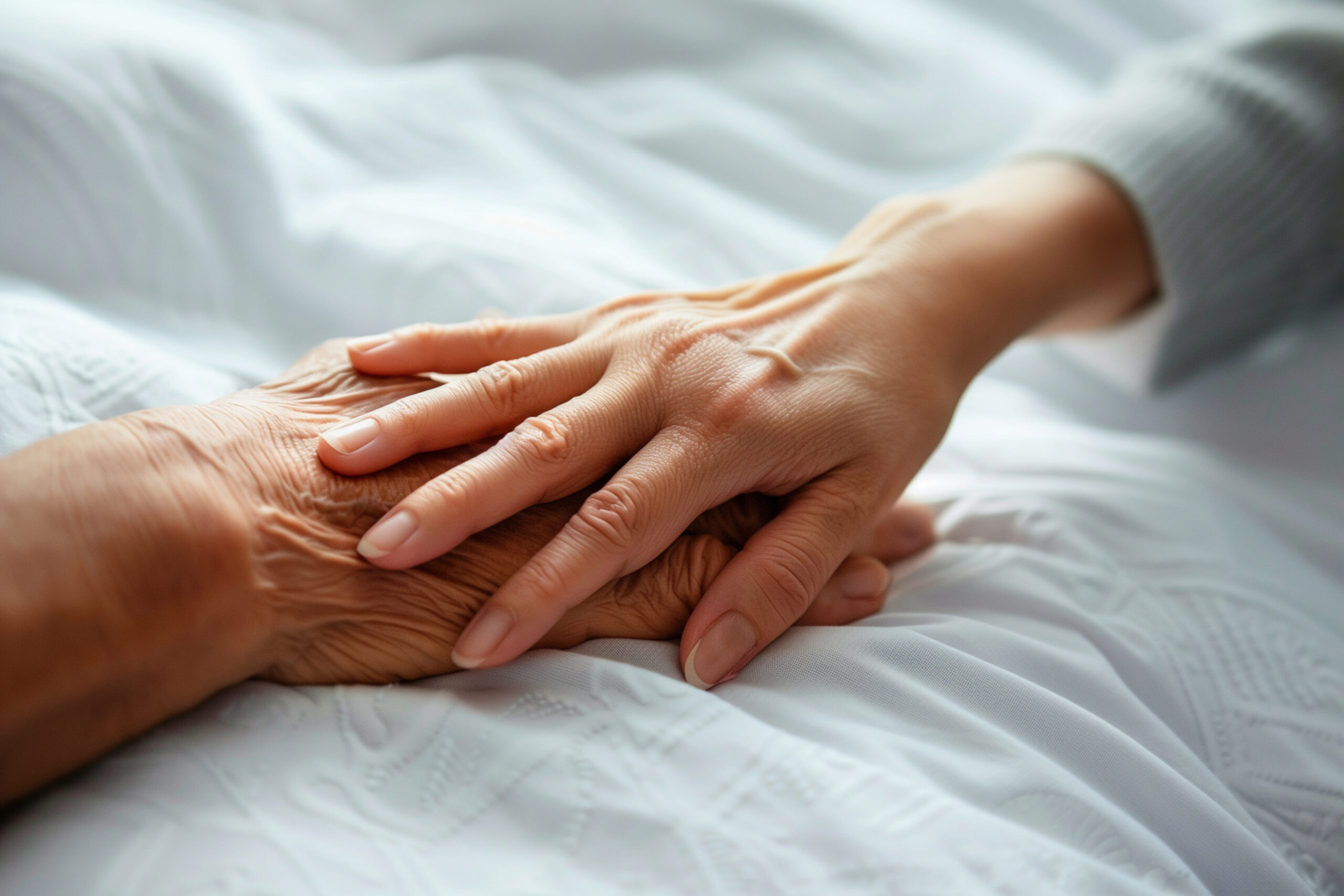 two-hands-are-resting-white-sheet-with-one-being-held-up