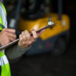 male-worker-writing-clipboard-1-min